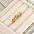 Blueyejewelry gold stacking ring with textured detailing and polished edges in a cream jewellery case.